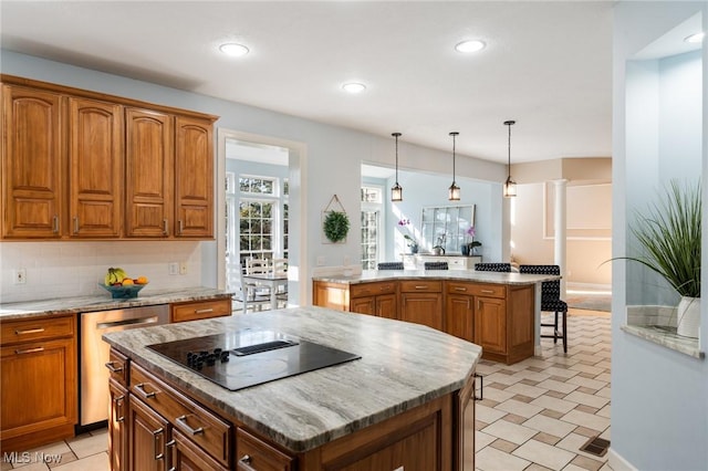 kitchen featuring backsplash, a center island, dishwasher, brown cabinetry, and black electric cooktop