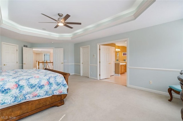 bedroom featuring light carpet, a ceiling fan, a raised ceiling, and baseboards