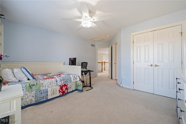 bedroom with a ceiling fan, a closet, carpet floors, baseboards, and attic access