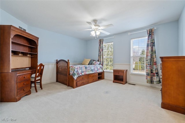 carpeted bedroom with baseboards and ceiling fan