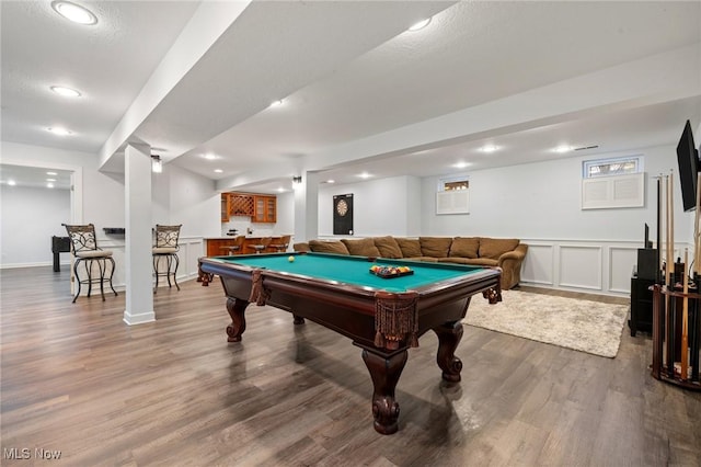 game room with indoor bar, recessed lighting, wood finished floors, a decorative wall, and billiards