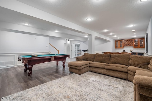 playroom with wood finished floors, recessed lighting, pool table, a decorative wall, and indoor bar