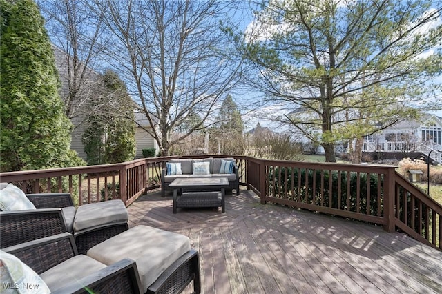 wooden terrace featuring outdoor lounge area