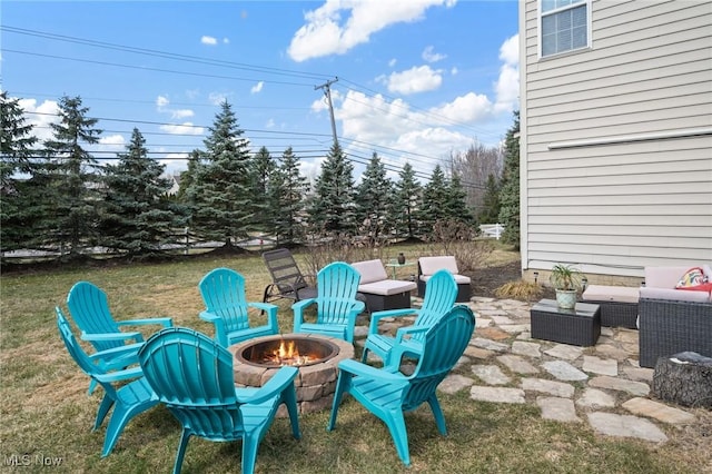 view of patio / terrace with an outdoor living space with a fire pit