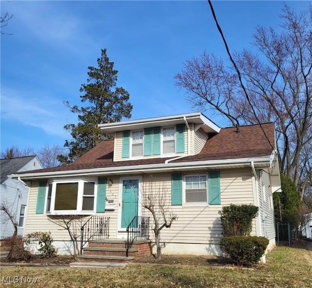 bungalow-style house featuring roof with shingles