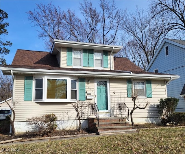 bungalow featuring roof with shingles