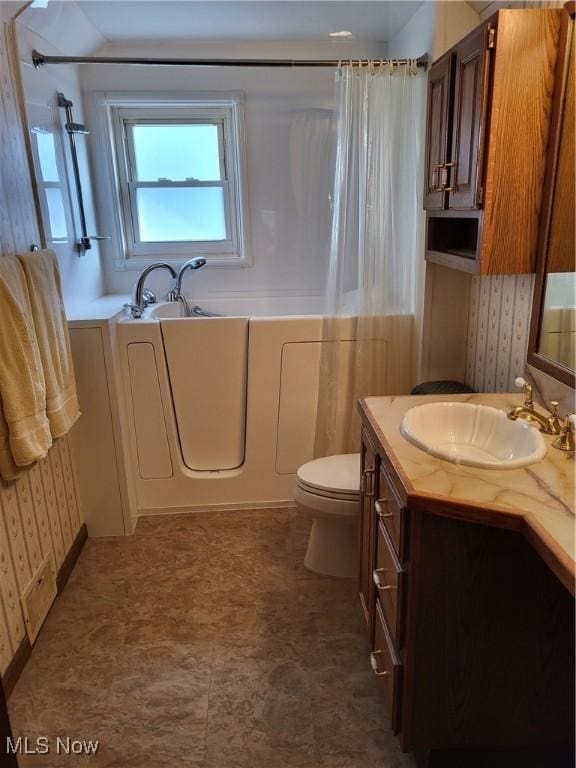 full bathroom with toilet, curtained shower, a bath, and vanity