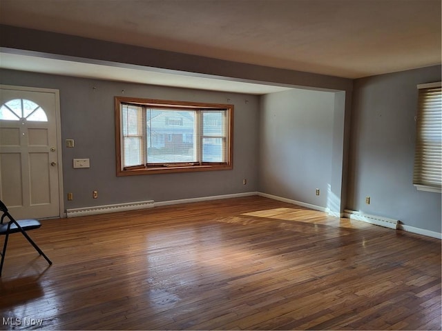 foyer entrance featuring plenty of natural light, hardwood / wood-style flooring, baseboards, and a baseboard radiator