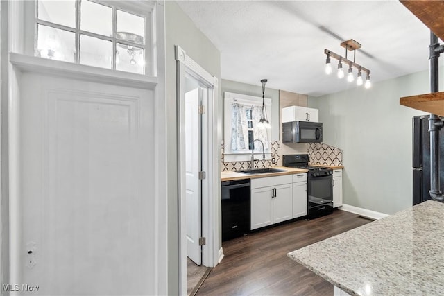 kitchen featuring black appliances, a sink, dark wood finished floors, white cabinets, and light countertops