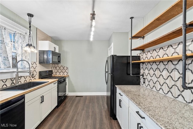 kitchen with dark wood finished floors, open shelves, a sink, black appliances, and backsplash