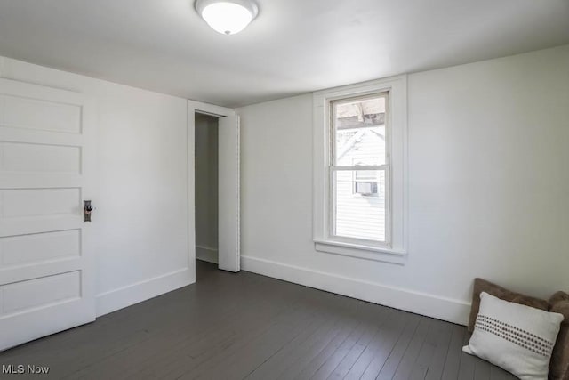 interior space with dark wood finished floors and baseboards