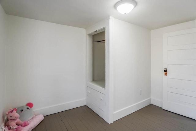 interior space with hardwood / wood-style floors and baseboards