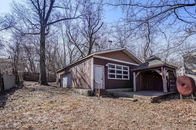 view of outdoor structure featuring a gazebo, entry steps, and fence