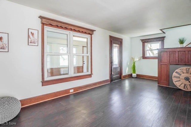 entrance foyer featuring baseboards and dark wood-style floors