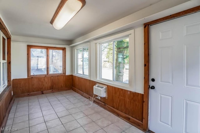 unfurnished sunroom with a wall mounted air conditioner