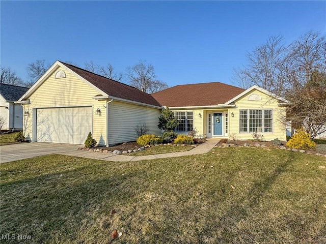 ranch-style home with a garage, concrete driveway, and a front lawn