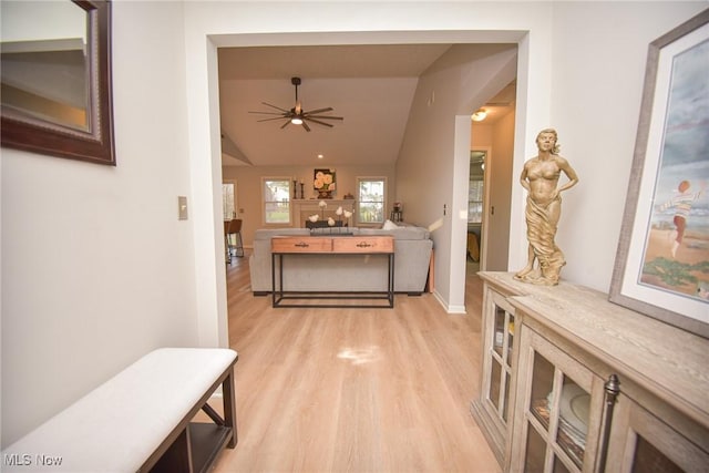 corridor featuring vaulted ceiling and light wood finished floors