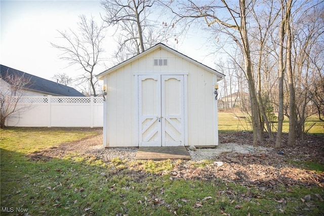 view of shed with fence