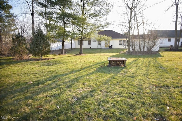 view of yard with a fire pit