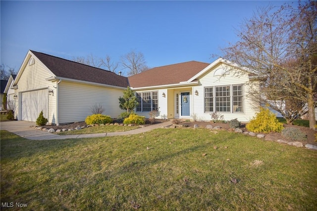 ranch-style home featuring a front lawn, an attached garage, and driveway