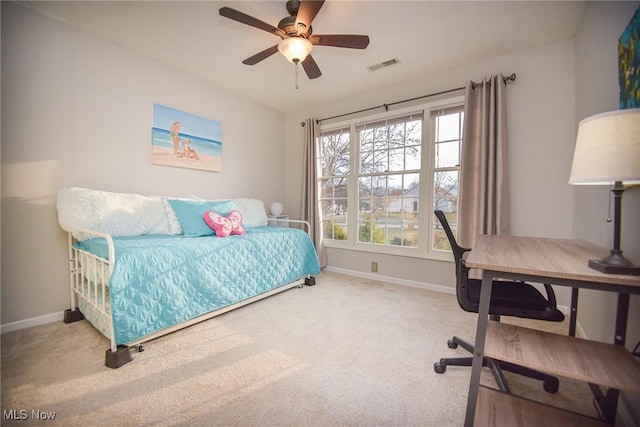 carpeted bedroom featuring visible vents, baseboards, and a ceiling fan