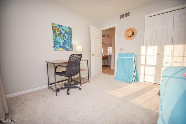 carpeted office with baseboards and visible vents