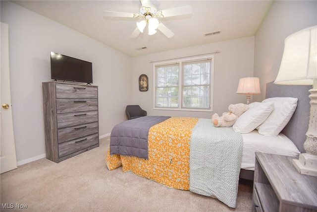 carpeted bedroom featuring baseboards, visible vents, and ceiling fan