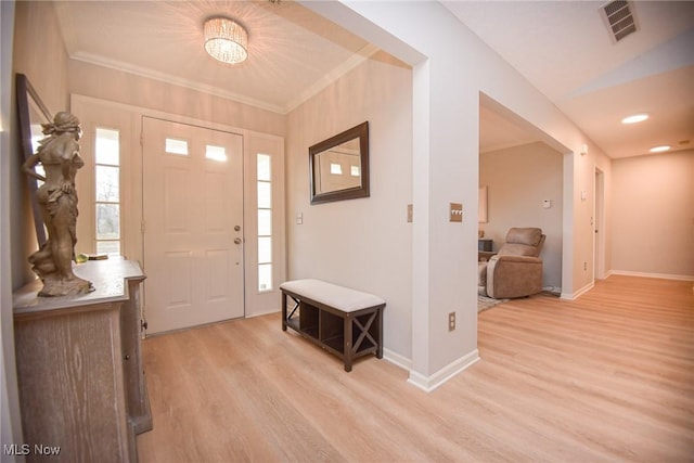 entrance foyer featuring light wood finished floors, plenty of natural light, baseboards, and visible vents