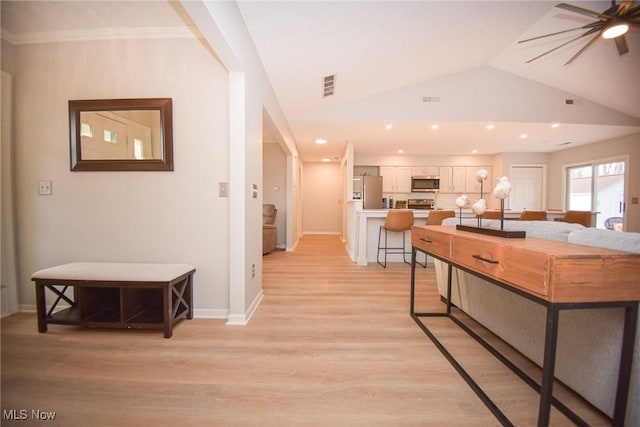 kitchen with visible vents, light countertops, vaulted ceiling, appliances with stainless steel finishes, and white cabinets