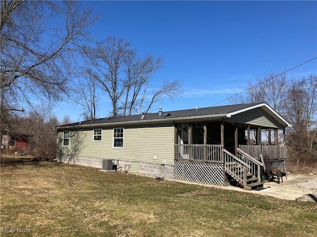 back of property with central AC unit, a lawn, and a porch