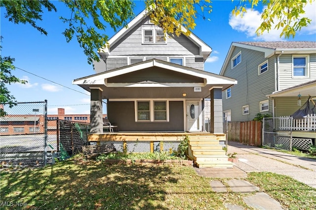 view of front of property with a porch and fence