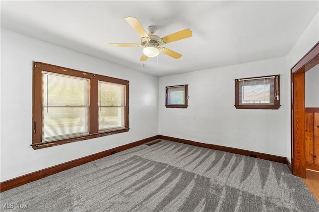 empty room featuring baseboards, carpet, and ceiling fan