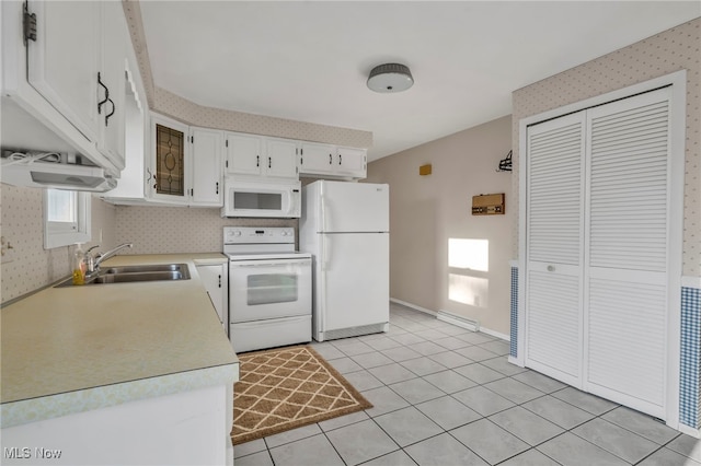 kitchen featuring white appliances, light tile patterned flooring, a sink, light countertops, and white cabinetry