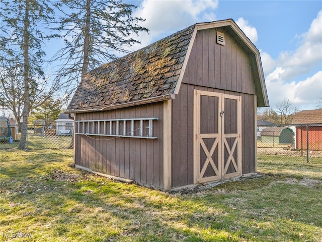 view of shed featuring fence