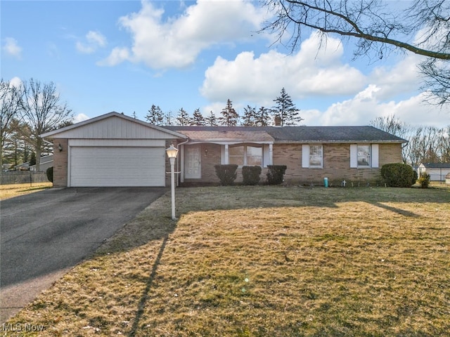 single story home featuring brick siding, an attached garage, driveway, and a front lawn