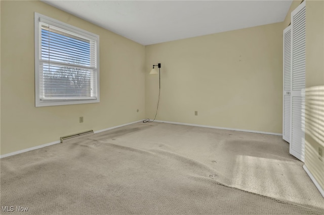 empty room with carpet and baseboards