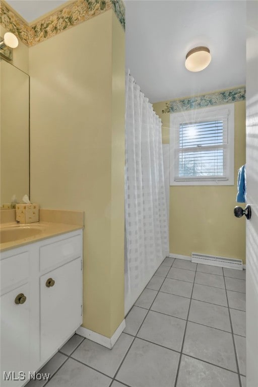 bathroom with tile patterned flooring, curtained shower, baseboards, vanity, and a baseboard radiator