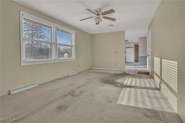 carpeted empty room featuring a baseboard heating unit, a ceiling fan, visible vents, and a baseboard radiator