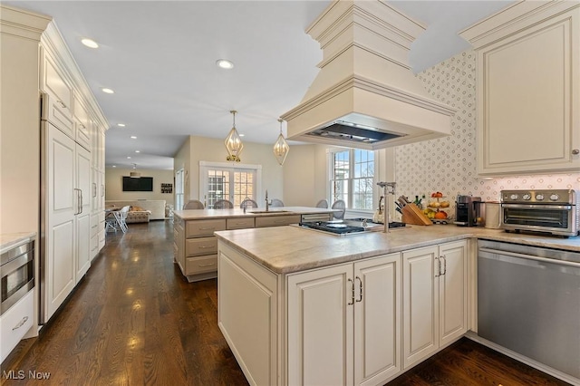 kitchen with a peninsula, custom range hood, dark wood-type flooring, and stainless steel appliances