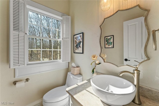 bathroom with toilet and vanity