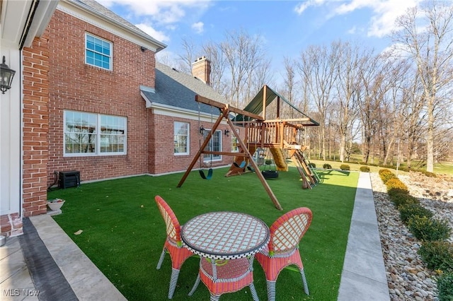 exterior space with a yard and central AC unit