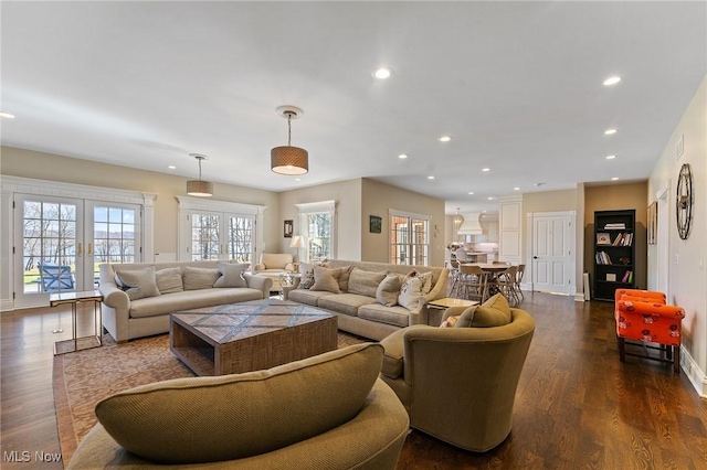 living room with dark wood finished floors, recessed lighting, french doors, and baseboards