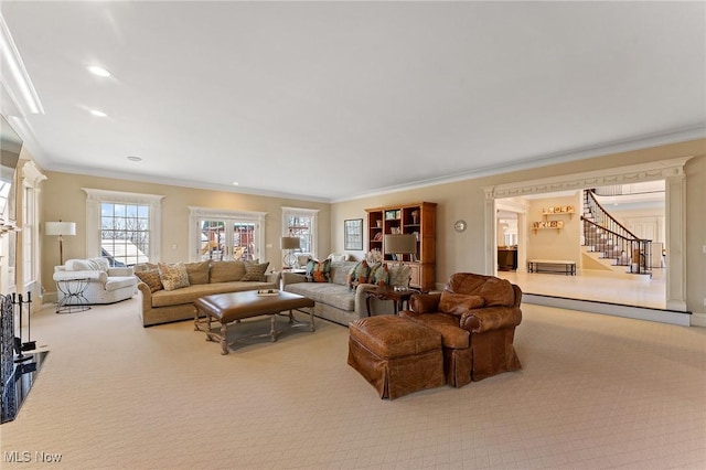 living area featuring stairway, recessed lighting, carpet floors, and ornamental molding