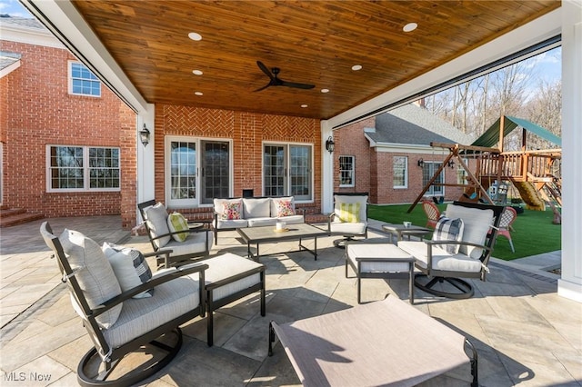 view of patio featuring a ceiling fan, outdoor lounge area, and a playground