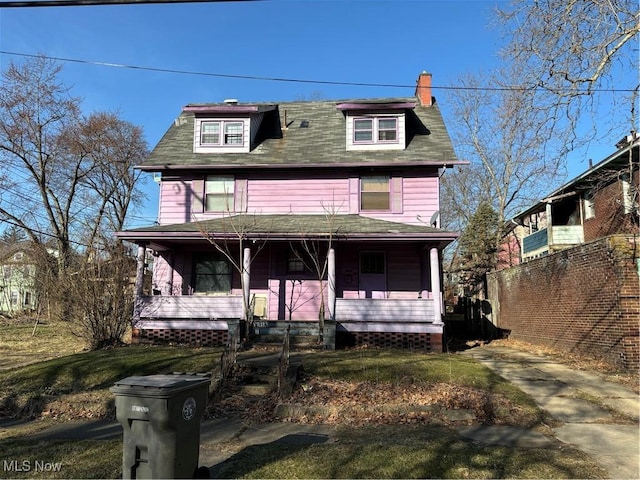 traditional style home with a porch and a chimney