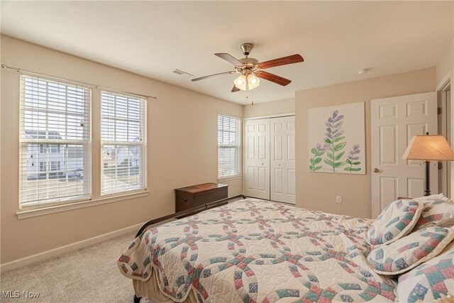 bedroom with visible vents, a ceiling fan, a closet, carpet, and baseboards