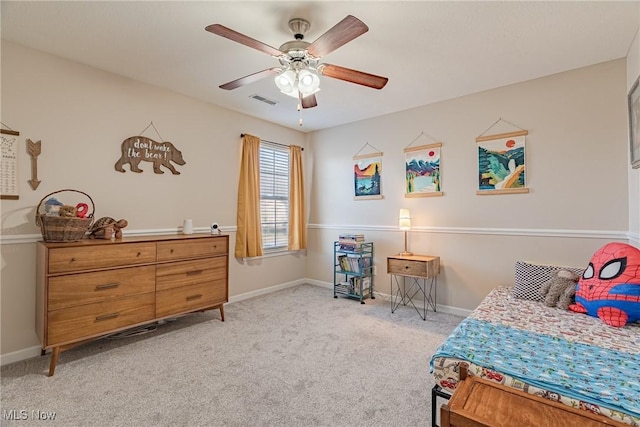 bedroom with visible vents, baseboards, light colored carpet, and a ceiling fan