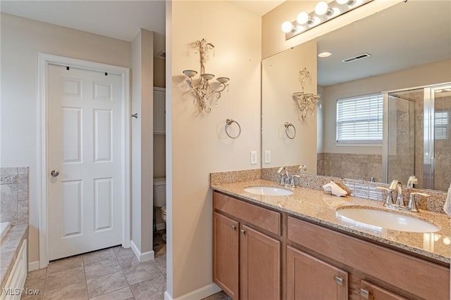 full bath featuring a sink, visible vents, a bath, and double vanity