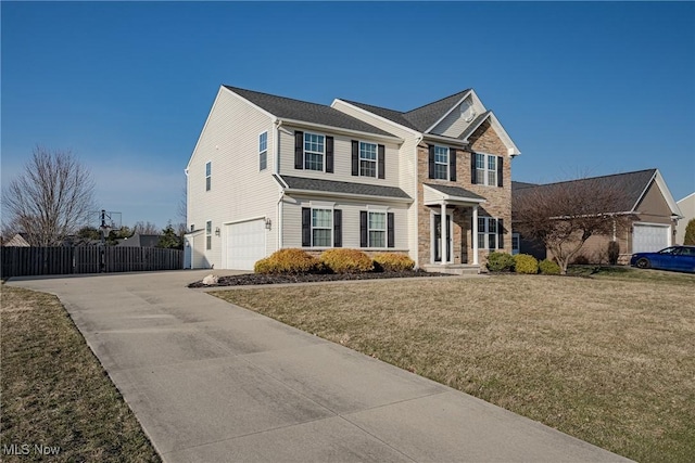 view of front of house featuring driveway, stone siding, fence, a front yard, and an attached garage