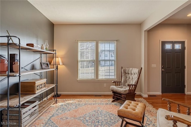 living area featuring wood finished floors and baseboards